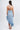 Abito asimmetrico azzurro con piume